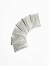 Load image into Gallery viewer, Set of Kind Bar shower spell packets arranged in a semi-circle on a white background
