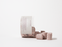 Load image into Gallery viewer, Set of pink bath bombs with a cylindrical container on a white background