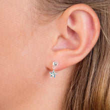 Load image into Gallery viewer, Close-up of ear wearing silver star-shaped drop earring, light skin, straight hair