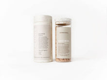 Load image into Gallery viewer, Two cylindrical products labeled 'Shower Spell' and 'Kind Bod' on a white background