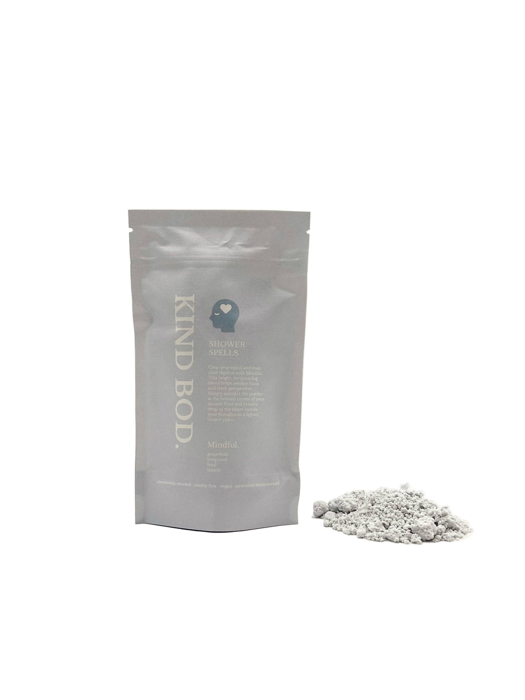 Gray packaging of 'Kind Bod' with a small pile of white capsules on a white background