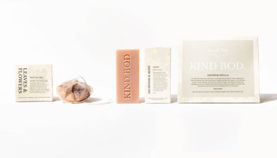 Collection of 'Kind Bod' products including soap and packaging on a white background